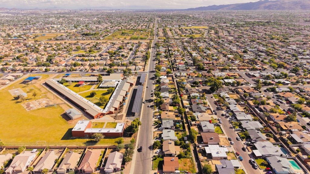 Aerial view of a Phoenix-area street grid stretching toward mountains on the horizon