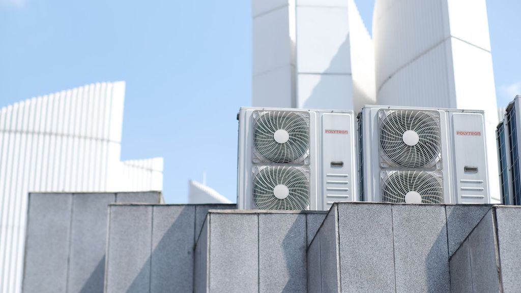 Outdoor air conditioning units mounted on a rooftop ledge